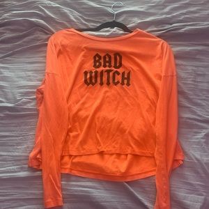 A Orange Long Sleeve with “Bad Witch” on front